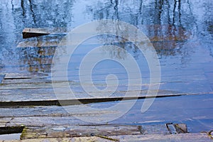 Planked footway under water.