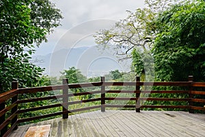 Planked viewing platform for visitors on mountainside in cloudy