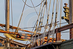 Planks, ropes, pulleys, tackle, and rigging of a replica of an old 1400's era sailing ship