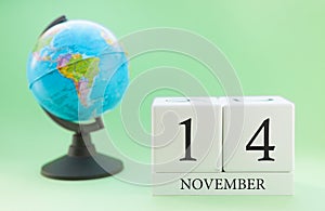 Planner wooden cube with numbers, 14 day of the month of November, autumn