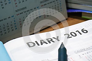 Daily planner year 2016 book on the wooden table