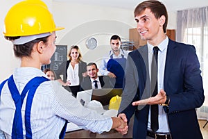 Planners with helmets in architecture bureau