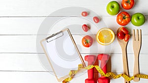 Planning for Diet Health eat and food.  Sport exercise equipment workout with fresh fruit and measuring tap, note pad for fitness