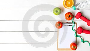 Planning for Diet Health eat and food.  Sport exercise equipment workout with fresh fruit, measuring tape, note pad for fitness st