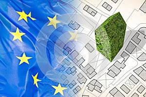 Planning green architecture in Europe - concept image with an imaginary city map against an European flag with a green building