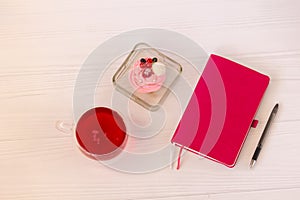 Planning laptop, high angle view of open blank notebook, cup and cupcake