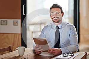 Planning made easy with technology. a smiling businessman using a digital tablet in an office.