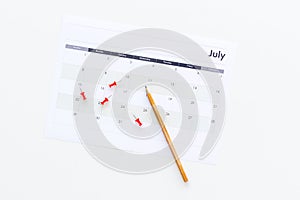 Planning. Point the date in calendar by pushpin. Set the goal. Choose date. Calendar white background top view copy