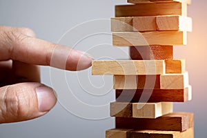 Planning, risk and strategy in business, businessman and engineer gambling placing wooden block on a tower