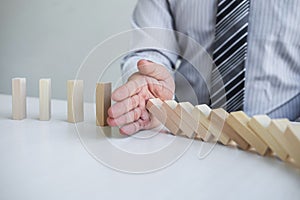 Planning Risk and Strategy in Business, Image of hand Businessman stopping and protection for collapse of wooden block game being