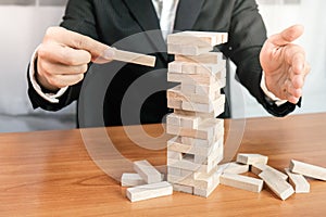 Planning risk and strategy in businessman gambling placing wooden block.Business concept for growth success process.