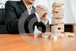 Planning risk and strategy in businessman gambling placing wooden block.Business concept for growth success process