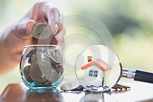 Planning savings money of coins to buy a home concept, mortgage and real estate investment. saving or investment for a house, a