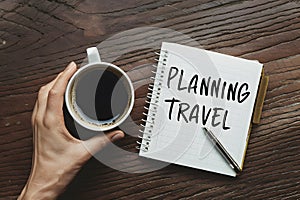 Planning travel with coffee cup, envisioning empty itinerary possibilities