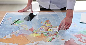 Planning your next adventure woman hand moves toy airplane on world map
