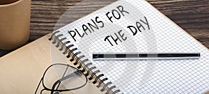 PLANS FOR THE DAY words written on office notebook. Concept in business