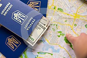 Plans for traveling in Ukraine with map of Kyiv city. Money, passport and map for adventure