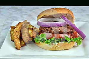 plant based burger with lettuce tomato and onions