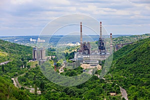 Plant or factory. Industrial area in a picturesque beautiful green area. Background with selective focus and copy space