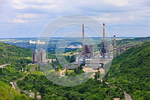 Plant or factory. Industrial area in a picturesque beautiful green area. Background with selective focus and copy space