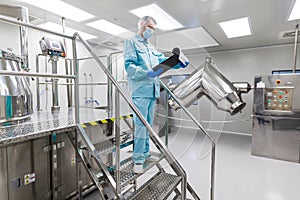 Plant picture, scientist is standing on ladder in laboratory, checking readings