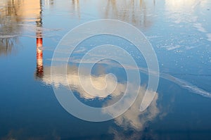 Plant pipes with smoke in the reflection of water