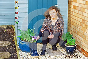 Plant pots in front of contemporary garden shed colours, in Spring.