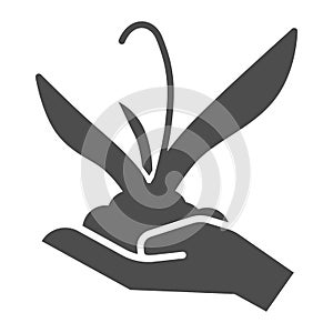 Plant sprout in hand solid icon, gardening concept, Flower plant in hand sign on white background, Human palm holds
