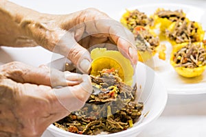 Plantain basket being filled with shredded meat