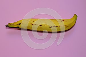 Plantain on millennial pink background. Eating in a vegetarian way is trend of young and conscious people