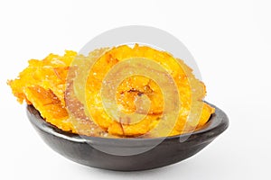 Plantain patacones on black dish