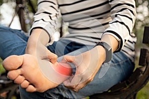 Plantar fasciitis,asian young woman holding her feet and massage with her hand suffer from tendon inflammation,female people sore