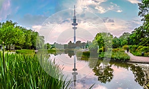 Planten um Blomen park with Heinrich-Hertz-Turm at sunset, Hamburg, Germany