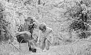 Planting flowers. Dad teaching little son care plants. Little helper in garden. Make planet greener. Growing plants