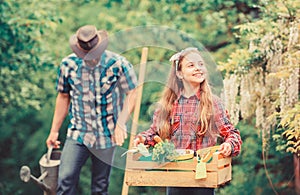 Plants need good care. little girl and happy man dad. earth day. family farm. spring village country. father and