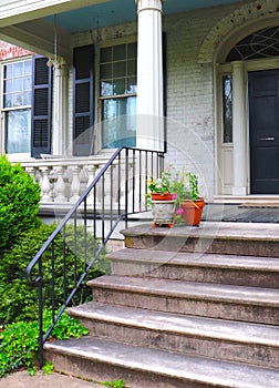 Plants in Pots Adorn Stone Steps at Entrance to a Building