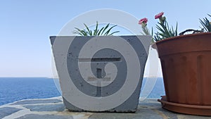 Plants in pots with christian cross symbol - photographed in monastery yard on Nisyros island, Greece