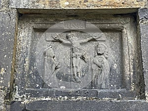 plaque with a crucifixion dated to 1625 Turlough Round Tower