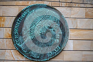 a plaque with an image of a man on it in front of a brick building