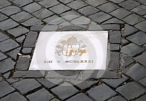 Plaque made by Benedict XVI on the site of the attack which bear photo