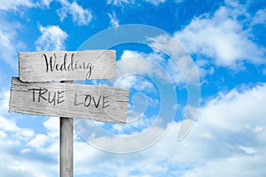 Plaques with inscriptions Wedding and True Love against beautiful blue sky, space for text