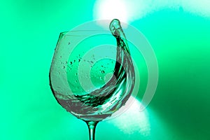 Plash of water from a wine glass on a light background