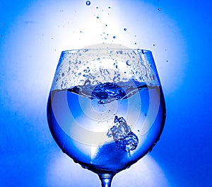 Plash of water from a wine glass on a light background