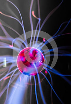 Plasma ball with magenta-blue flames photo