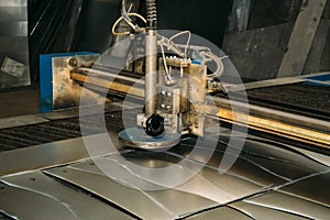 Plasma cut machine cutting steel sheet. Lasercutting of industrial iron works photo