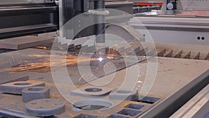 Plasma cutting machine working with sheet metal with sparks