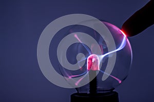 A plasma lamp with pink electricity rays photo