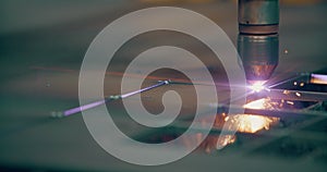 Plasma laser cutting metal sheet with sparks Welding