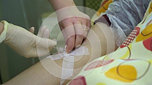 Plasmapheresis. Cleaning the patientâ€™s blood through the device. A nurse inserts a medicine drip into a patient`s vein.