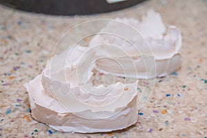 Plaster impression of teeth. Dental plaster mold. Dental mold showing teeth on a table viewed side on in a dentistry